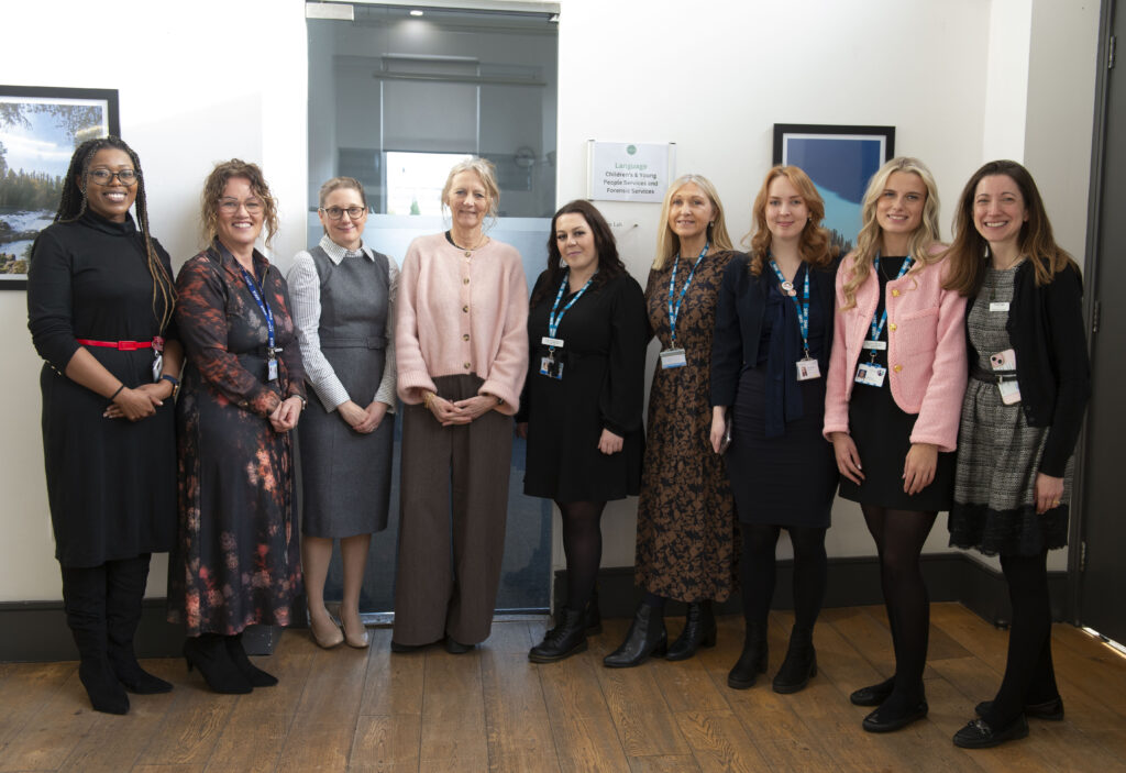 Nine people line up to for a phopograph at the celebration event to mark the first six months of the the Burmantofts, Harehills, and Richmond Hill Women’s* Health Hub
